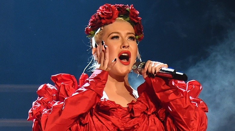 Christina Aguilera singing in red outfit