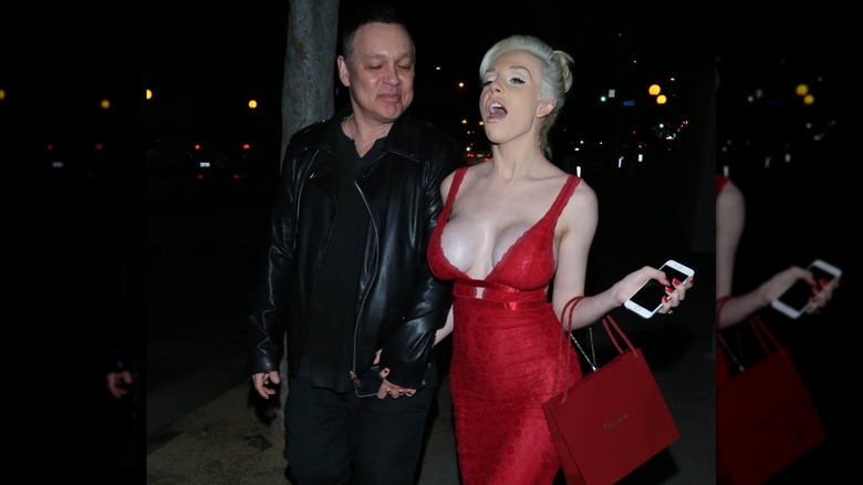 Doug Hutchison and Courtney Stodden walking hand in hand while married.