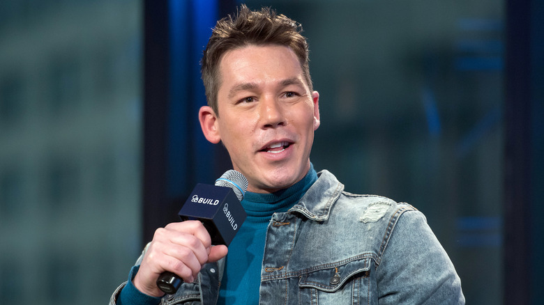 David Bromstad speaking in a microphone at press event