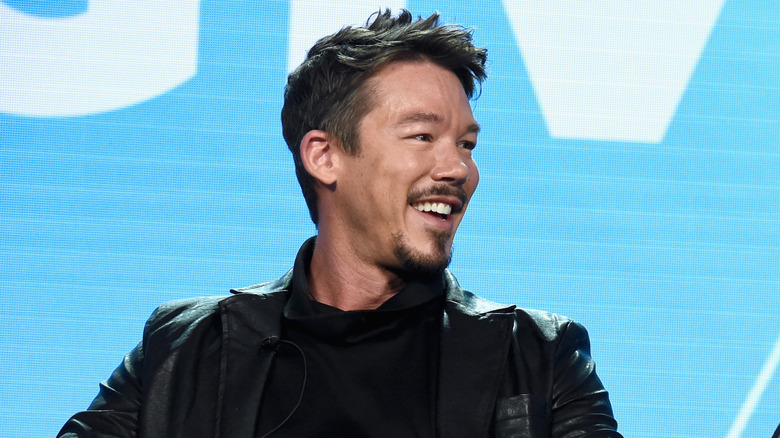 David Bromstad wearing a black coat and shirt at HGTV event