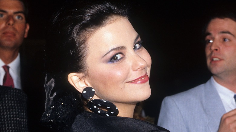 Delta Burke smiling over shoulder 