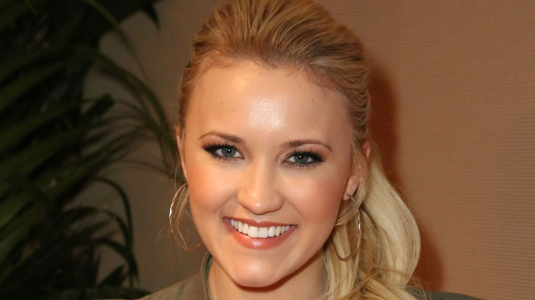 Emily Osment smiles at camera