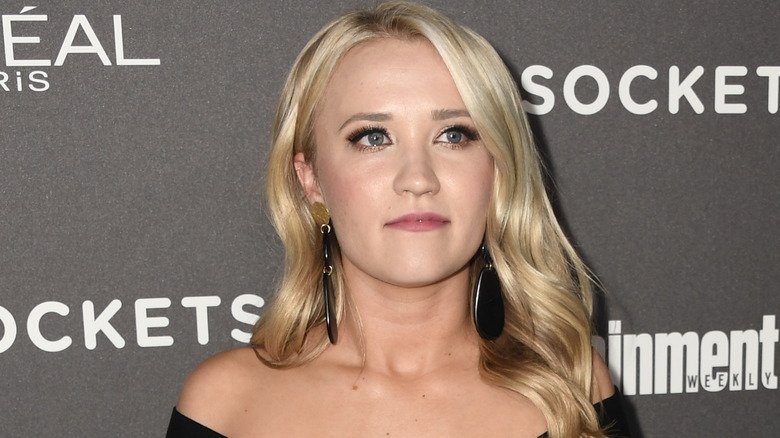 Emily Osment looks on