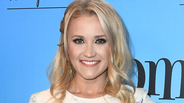 Emily Osment smiles at camera