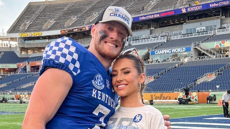 Gia Duddy and Will Levis pose at a game