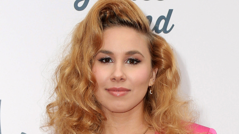 Haley Reinhart on red carpet, softly smiling