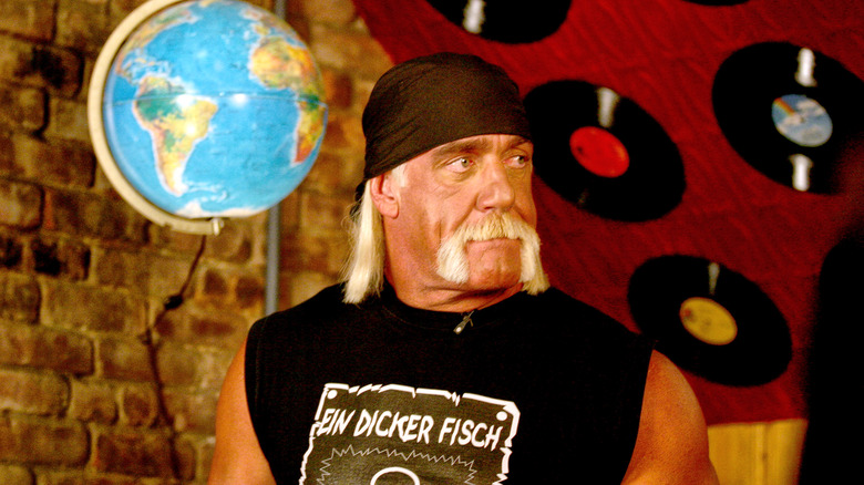 Hulk Hogan with record albums, looking away