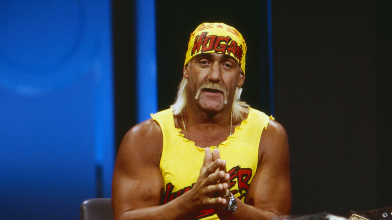 Hulk Hogan seated and sleeping