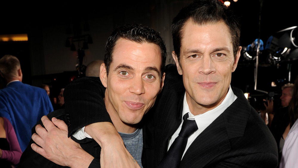 Steve-O and Johnny Knoxville hugging at an event 