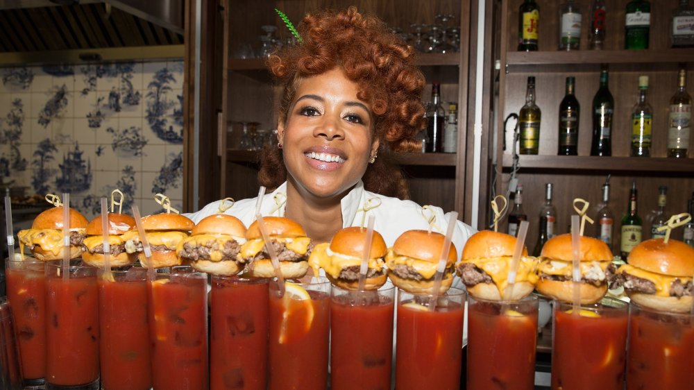 Kelis posing with cocktails and sliders