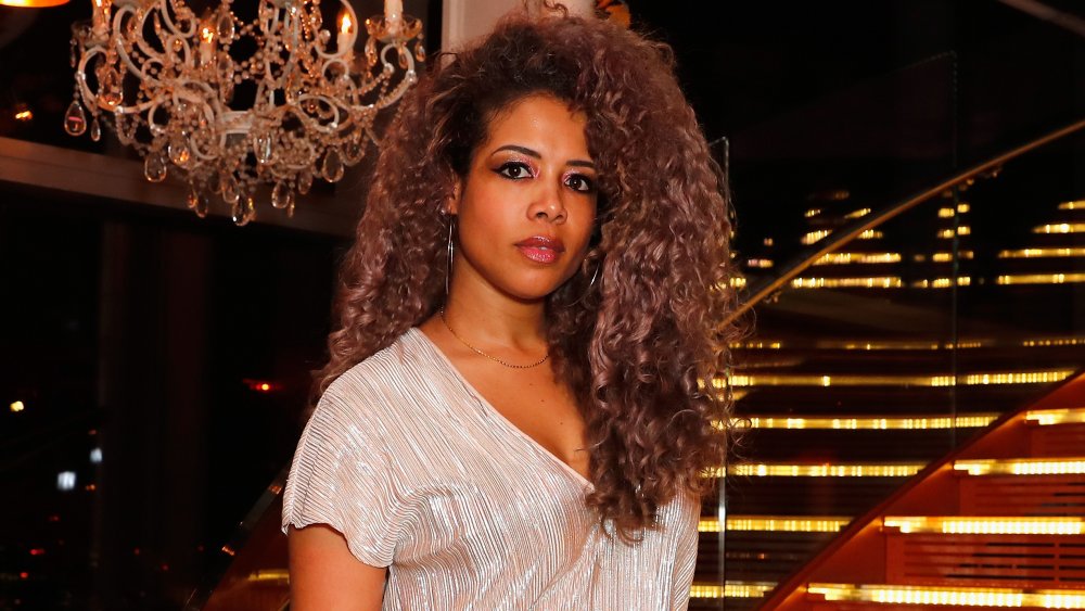 Kelis posing in a glittery silver top