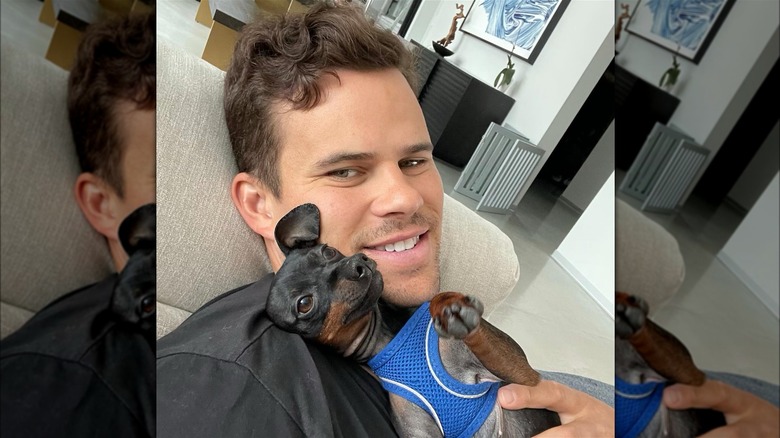 Kris Humphries smiling with his dog