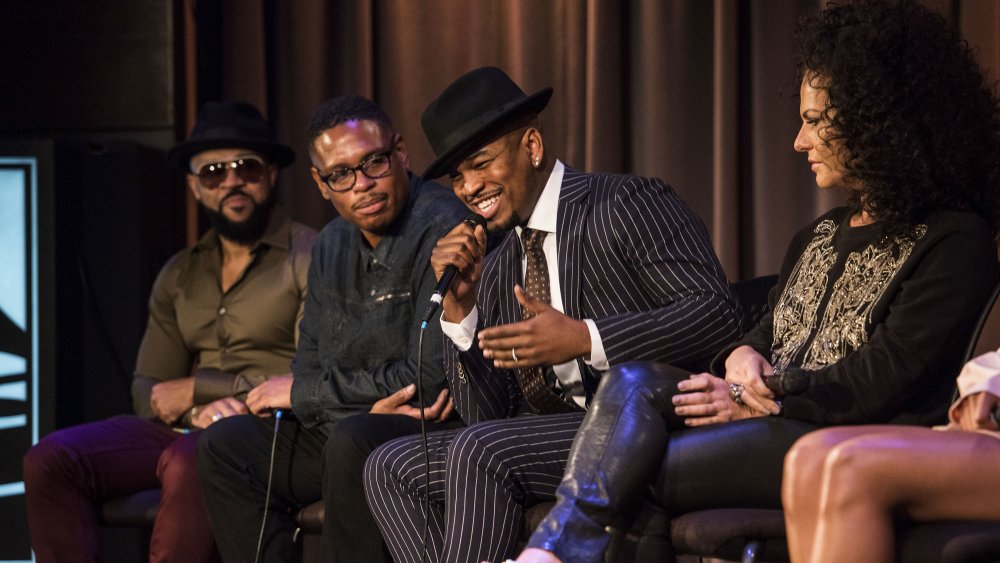 Ne-Yo in pinstripe suit, talking into a microphone on a panel