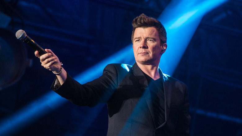 Rick Astley holding microphone