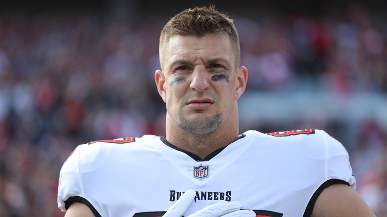 Rob Gronkowski wearing a white Buccaneers football jersey and white gloves