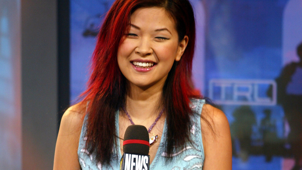 SuChin Park smiling while holding an MTV News microphone