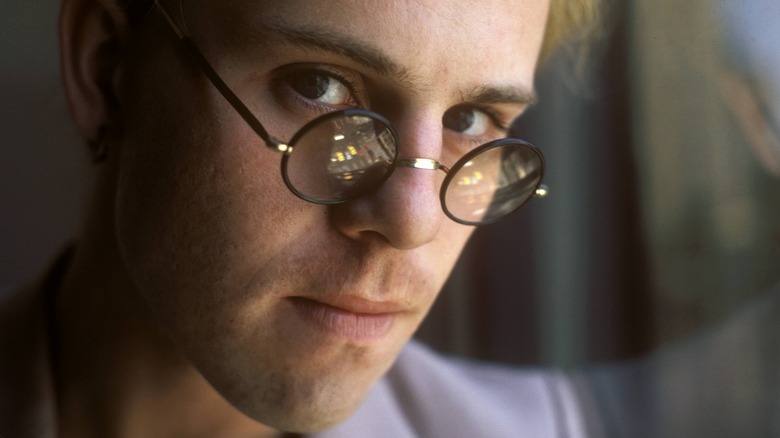 Thomas Dolby posing in round glasses