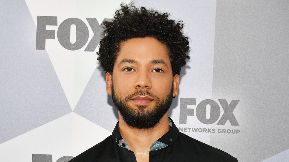 Jussie Smollett posing at a Fox event with a neutral expression