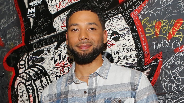 Jussie Smollett posing at an event with a small smile