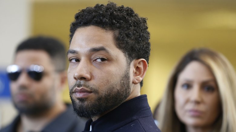 Jussie Smollett looking off to the side with a serious expression