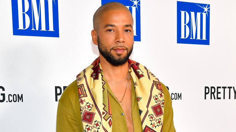 Jussie Smollett posing on the red carpet with a neutral expression