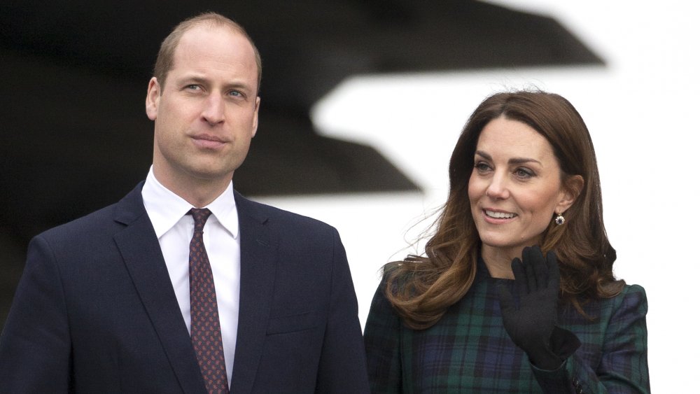 Prince William with a serious expression, Kate Middleton smiling