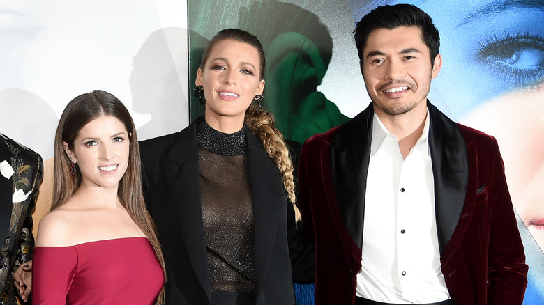 Anna Kendrick, Blake Lively, and Henry Golding smiling