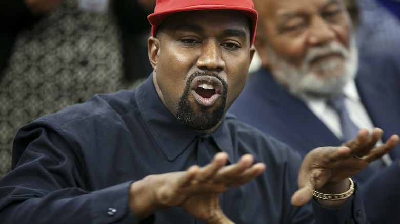 Kanye West talking with hands outstretched