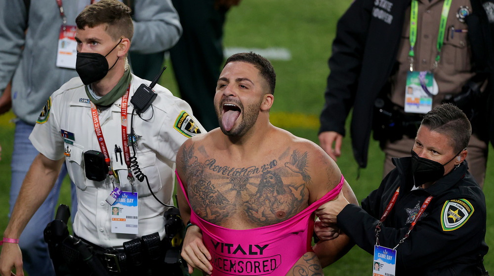 A man interrupts Super Bowl LV surrounded by cops