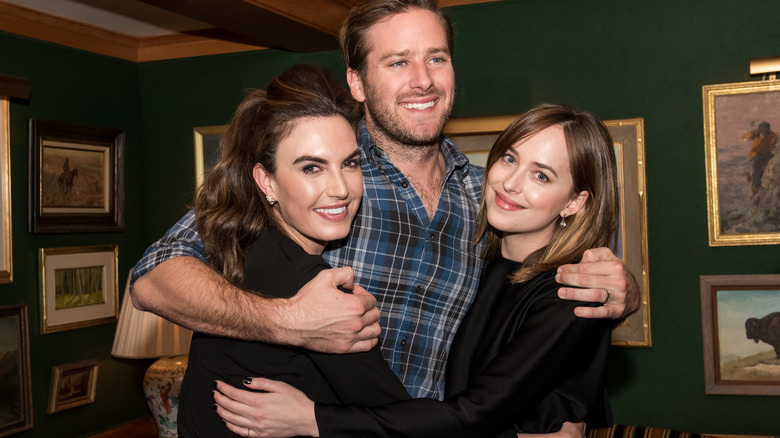 Elizabeth Chambers, Armie Hammer, and Dakota Johnson smiling