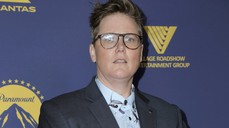 Hannah Gadsby in glasses not smiling