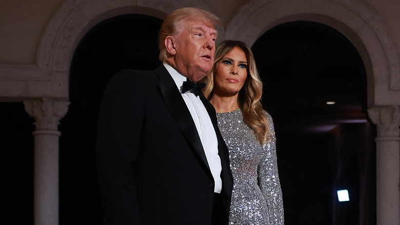 Donald Trump walks in front of Melania Trump