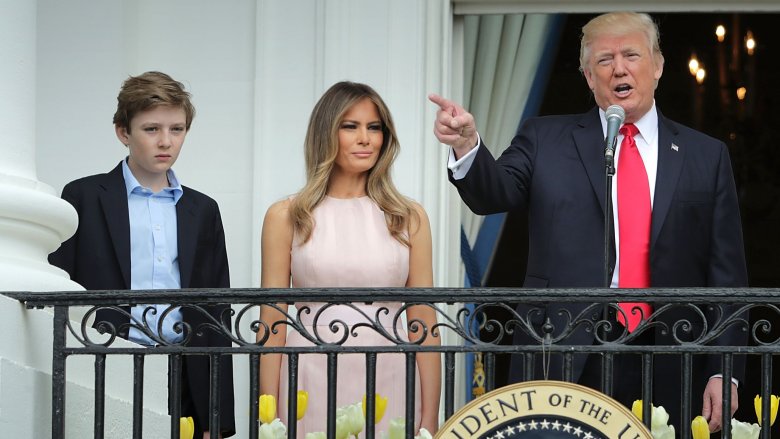 Barron Trump and Melania Trump watching Donald Trump give a speech