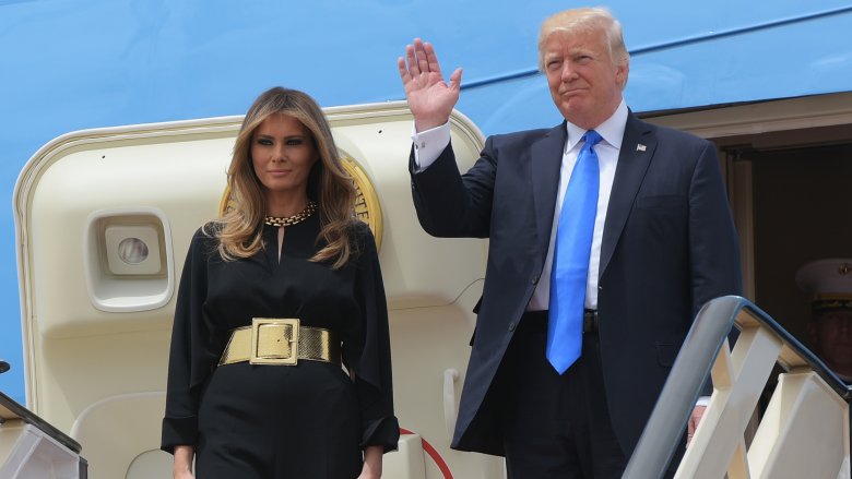 Melania Trump posing and Donald Trump waving