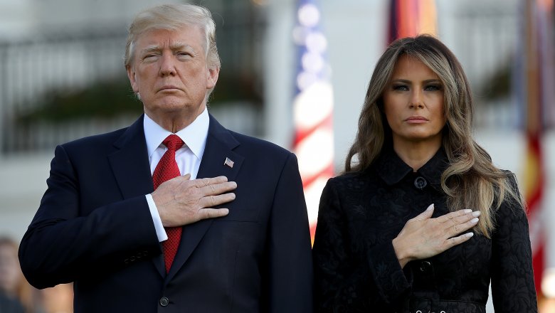 Donald and Melania Trump with hands over their heart