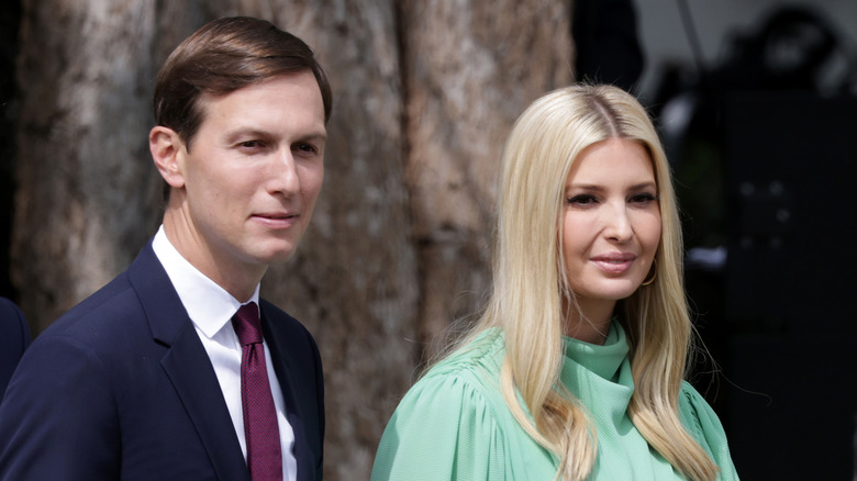 Jared Kushner in navy blue suit and Ivanka Trump in teal dress 