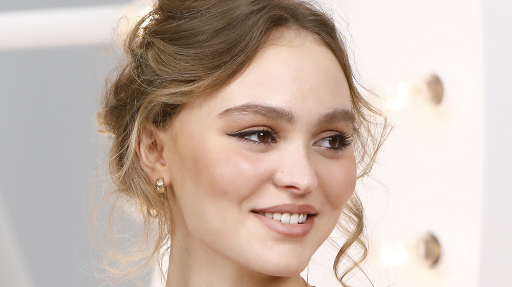 Lily-Rose Depp smiles for the cameras at a fashion event