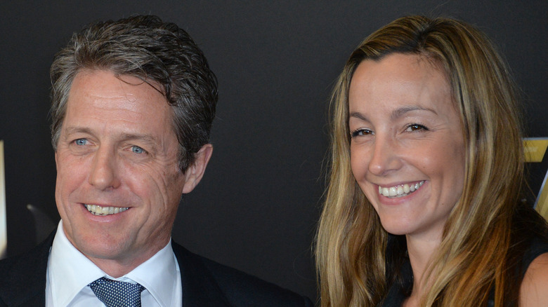 Hugh Grant and Anna Eberstein smiling