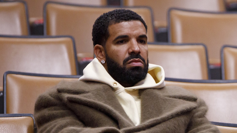 Drake sitting in stadium frowning