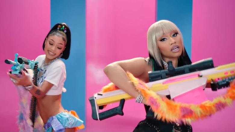 Coi Leray, Nicki Minaj posing with prop guns