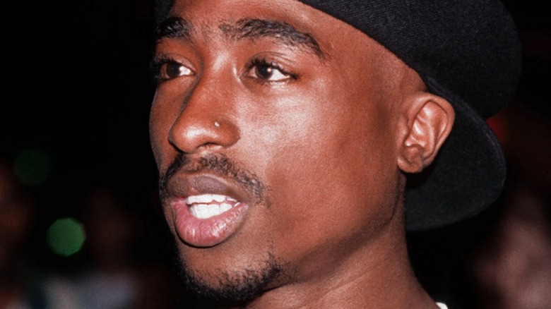 Tupac wears baseball hat backwards