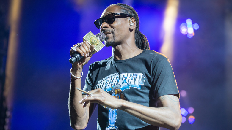 Snoop Dogg holding a microphone