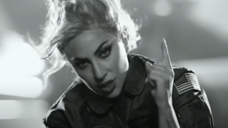 Lady Gaga sings "Hold My Hand" in the song's music video