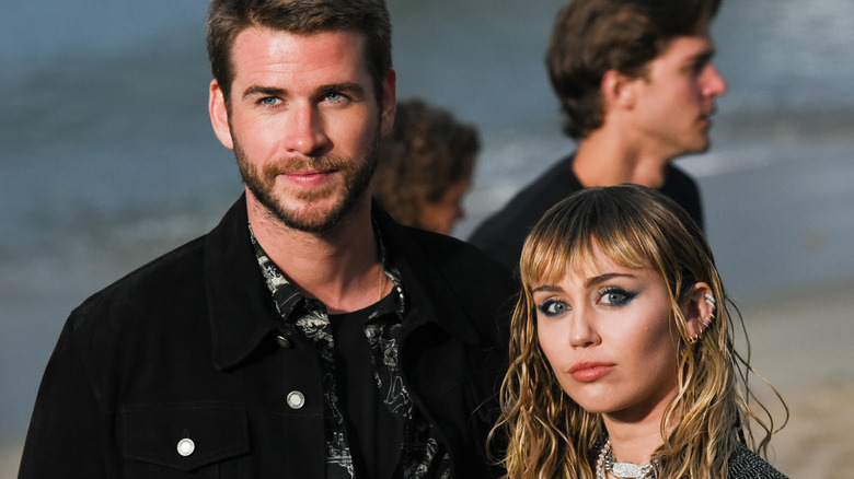 Miley Cyrus and Liam Hemsworth posing