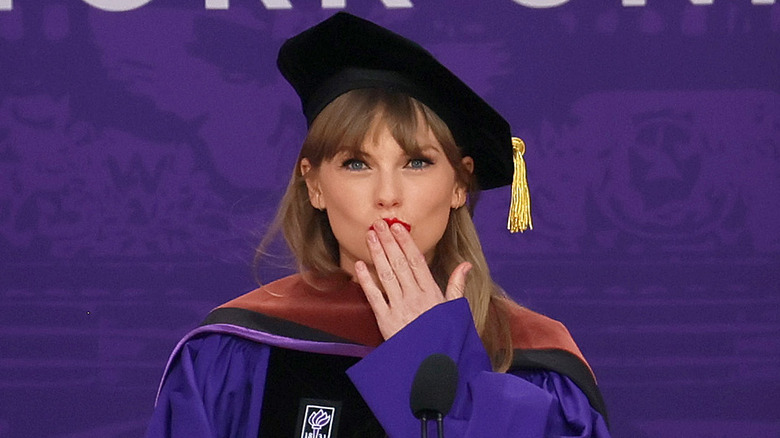 Taylor Swift placing fingers on lips