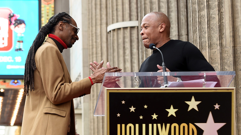 Snoop Dogg and Dr. Dre slapping hands