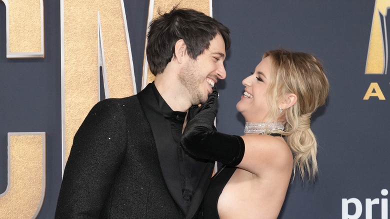 Morgan Evans and Kelsea Ballerini smiling at each other