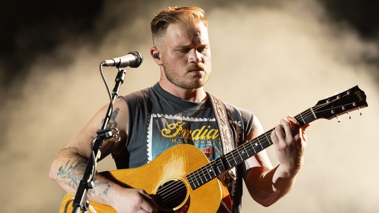 Zach Bryan playing guitar