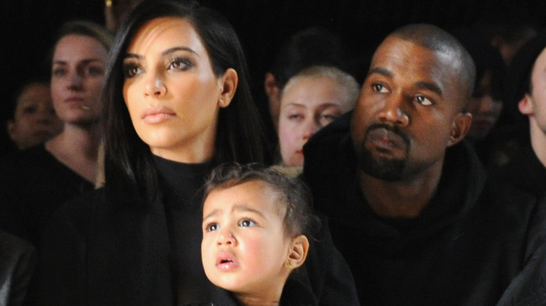 Kanye West, Kim Kardashian, and North West at a fashion show