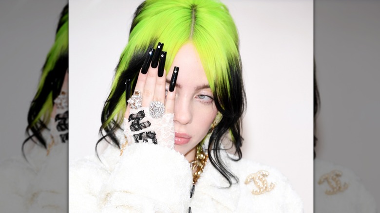 Billie Eilish with hand over face in close-up